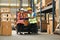 Warehouse workers, sitting on forklift truck and checking newly arrived goods in large warehouse