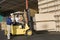 Warehouseman And Forklift Truck Driver In Timber Factory
