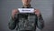 Warfare word written on sign in hands of male soldier, military conflict