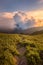 Warm afternoon sun setting down over the clouds in warm colors on a hiking path from the top of HeHuanShan in Taiwan