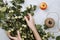 Warm autumn flatlay with apple branches, fruits, twine and woman`s hands