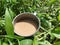 warm chocolate milk in an iron cup with a grass background