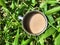 warm chocolate milk in an iron cup with a grass background