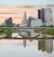 Warm colored morning clouds over Columbus Ohio with river reflection