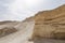 Warm colors background. Big yellow sandstone ont the hill against the skyscape. Textured carved mountain and bright sky. Judean