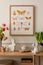 Warm composition of easter living room interior with mock up poster frame, wooden sideboard, vase with tulips, easter bunny,