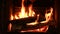 Warm cozy burning fire in a brick fireplace, close-up shot 4k