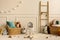 Warm and cozy kids room interior with white stool, wicker basket, colorful pillow, stylish toys, plush koala, wooden blockers,