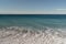 Warm day on a Cannes beach with azure waves of mediterranean sea