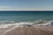 Warm day on a Cannes beach with azure waves of mediterranean sea