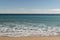 Warm day on a Cannes beach with azure waves of mediterranean sea