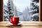 A warm drink cup in a window frame against the backdrop of winter scenery creates a cozy and hygge ambiance.