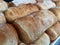 Warm fresh breads in a bakery shelf display