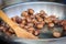 Warm fried edible chestnuts castanea sativa lie in a frying pan