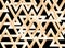 Warm gold triangles pattern on black.