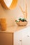 Warm interior of a living room with a mirror and a desk with little lavender bags in a basket and dried reed