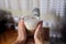 Warm and Inviting: Female Hands Cradling a Glass Cup of Coffee with Milk Foam