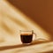 A warm, inviting image of a cup of black coffee, highlighted by soft shadows and light.