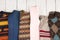 Warm knitted sweaters on wooden shelf. Set of winter pullovers with different ornament