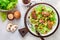 Warm lettuce salad with chicken liver, fried mushrooms, olive oil, seasonings and balsamic