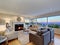 Warm light brown living room with panoramic window view.