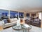 Warm light brown living room with panoramic window view.