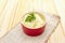 Warm mashed potatoes in a ceramic bowl with fresh parsley. On a vintage linen napkin on a stone background, close up