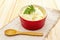 Warm mashed potatoes in a ceramic bowl with fresh parsley. On a vintage linen napkin on a stone background, close up