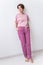 Warm pink kit for sleeping. Soft cotton t-shirt and pants. Comfortable clothes for healthy sleep. Pajamas concept.