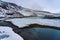 Warm river water and mountains in snow in krysuvik seltun on reykjanes peninsula in Iceland winter landscape .