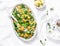 Warm salad with broccoli, pumpkin and couscous on a light background, top view. Vegetarian food concept.