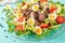 Warm salad from chicken liver, avocado, tomato and quail eggs. Healthy dinner.