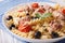 Warm salad fusilli pasta, tuna and tomatoes close up. horizontal