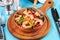 Warm salad of grilled fish pieces, shrimps and mussels in a frying pan