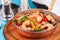Warm salad of grilled fish pieces, shrimps and mussels in a frying pan