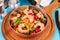 Warm salad of grilled fish pieces, shrimps and mussels in a frying pan