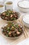 Warm sea cabbage salad with tofu in bowls, vertical