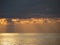 Warm sea sunset with giants cumulonimbus clouds in the sky and sun rays through . Tuscany, Italy