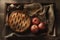 Warm side lit high angle still life of a fresh baked apple pie and apples in a wood box on burlap surface