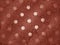 Warm sienna color dotted pattern on wavy background