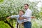 A warm spring day in a blooming garden. A cheerful little boy and his father play outdoors in the Park. The father circles around