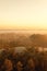 Warm sunrise at a swamp covered in fog. Sunshine beats through the thick mist with tree silhouettes and lakes