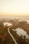 Warm sunrise at a swamp covered in fog. Sunshine beats through the thick mist with tree silhouettes and a path at Kemeri National