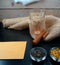 Warm Tea ambiance with cinnamon, chamomile, green tea jasmine with candle and burlap at wooden background with rabbit skin