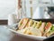 Warm tone of stack of sandwich on wooden brown table near the br