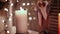 Warm-toned Christmas footage: candle and handmade decorations on the window