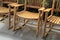 Warm-toned wood of three Adirondack rocking chairs