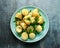 Warm vegetarian new baby potato salad with petit pois peas, Dijon mustard and capers dressing, served with fresh dill