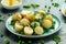 Warm vegetarian new baby potato salad with petit pois peas, Dijon mustard and capers dressing, served with fresh dill