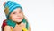 Warm woolen accessories. Girl happy face white background. Hat and scarf keep warm. Kid wear warm knitted hat and long